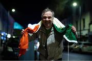 7 December 2020; Dundalk supporter 'Maxi' Mark Kavanagh, with an Irish tri-colour given to him by the late Dundalk videographer Harry Taaffe, following the Dundalk squads return to Dundalk after defeating Shamrock Rovers in the Extra.ie FAI Cup Final match in the Aviva Stadium in Dublin earlier. The players and staff stayed on the bus due to COVID-19 restrictions. Photo by Ben McShane/Sportsfile