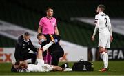 10 December 2020; David McMillan of Dundalk is treated for an injury by Dundalk team physio Danny Miller during the UEFA Europa League Group B match between Dundalk and Arsenal at the Aviva Stadium in Dublin. Photo by Ben McShane/Sportsfile
