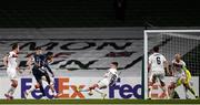 10 December 2020; Joe Willock of Arsenal shoots to score his side's third goal despite the efforts of Darragh Leahy of Dundalk during the UEFA Europa League Group B match between Dundalk and Arsenal at the Aviva Stadium in Dublin. Photo by Ben McShane/Sportsfile