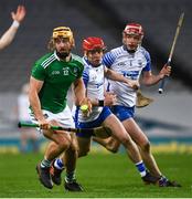 13 December 2020; Tom Morrissey of Limerick breaks clear from Darragh Lyons and Calum Lyons of Waterford during the GAA Hurling All-Ireland Senior Championship Final match between Limerick and Waterford at Croke Park in Dublin. Photo by Ray McManus/Sportsfile