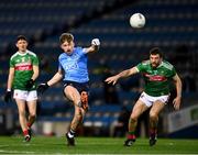 19 December 2020; Seán Bugler of Dublin, under pressure from Chris Barrett of Mayo, kicks his side's third point, in the 11th minute, during the GAA Football All-Ireland Senior Championship Final match between Dublin and Mayo at Croke Park in Dublin. Photo by Ray McManus/Sportsfile