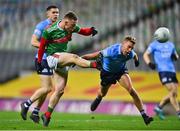 19 December 2020; Ryan O'Donoghue of Mayo scores a point despite the efforts of Jonny Cooper of Dublin during the GAA Football All-Ireland Senior Championship Final match between Dublin and Mayo at Croke Park in Dublin. Photo by Eóin Noonan/Sportsfile
