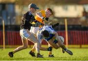 20 December 2020; Connor Eccles of Monaghan is tackled by Dan McNicholl and Shay Laverty of Antrim during the Electric Ireland Ulster Minor Football Championship Quarter Final match between Antrim and Monaghan at Corrigan Park in Belfast. Photo by Philip Fitzpatrick/Sportsfile