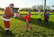 20 December 2020; Santa Claus hands out a present to Gorey RFC Minis' Julia Szewczuk during Gorey RFC Minis Training at Gorey RFC in Gorey, Wexford. Photo by Seb Daly/Sportsfile