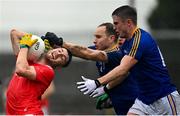 1 November 2020; John Cluttercuck of Louth is tackled by Gary Rogers of Longford during the Leinster GAA Football Senior Championship Round 1 match between Louth and Longford at TEG Cusack Park in Mullingar, Westmeath. Photo by Eóin Noonan/Sportsfile