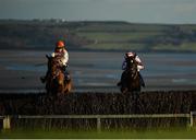 1 January 2021; Cash Me Outside, left, with Richard Condon up, jumps the fourth alongside Brex Drago, with Jonathan Moore up, during the VS Direct No Limits Marketing Rated Novice Steeplechase at Tramore Racecourse in Waterford. Photo by Seb Daly/Sportsfile
