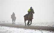 7 January 2021; Trainer Diego Dias schools a horse on the gallops at the Curragh, in Kildare. Photo by Seb Daly/Sportsfile