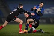 8 January 2021; Dave Kearney of Leinster evades the tackle of Ulster's Billy Burns, left, and James Hume during the Guinness PRO14 match between Leinster and Ulster at the RDS Arena in Dublin. Photo by Seb Daly/Sportsfile