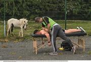 18 July 2020; David Keogh of Thomas Davis receives treatment from team physio Carl O'Toole ahead of the Dublin County Senior Hurling Championship Group 4 Round 1 match between Cuala and Thomas Davis at Bray Emmets GAA club in Bray, Wicklow. Competitive GAA matches have been approved to return following the guidelines of Phase 3 of the Irish Government’s Roadmap for Reopening of Society and Business and protocols set down by the GAA governing authorities. With games having been suspended since March, competitive games can take place with updated protocols including a limit of 200 individuals at any one outdoor event, including players, officials and a limited number of spectators, with social distancing, hand sanitisation and face masks being worn by those in attendance among other measures in an effort to contain the spread of the Coronavirus (COVID-19) pandemic. Photo by Ramsey Cardy/Sportsfile