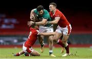 7 February 2021; Robbie Henshaw of Ireland is tackled by Johnny Williams, left, and George North of Wales during the Guinness Six Nations Rugby Championship match between Wales and Ireland at the Principality Stadium in Cardiff, Wales. Photo by Gareth Everett/Sportsfile