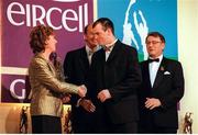 4 December 1998; Clare hurler Ollie Baker is congratulated by Eircell CEO Stephen Brewer before being presented with his Eircell GAA All Star award by President Mary McAleese, in the company of Uachtarán Chumann Lúthchleas Gael Joe McDonagh, right, during the 1998 Eircell GAA All Star Awards Banquet at The Burlington Hotel in Dublin. Photo by Brendan Moran/Sportsfile