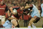 31 January 2004; Rob Henderson, Munster, is tackled by Kevin Zhakata, left, and Julien Bouic, Bourgoin. Heineken European Cup 2003-2004, Pool 5, Round 6, Munster v Bourgoin, Thomond Park, Limerick. Picture credit; Matt Browne / SPORTSFILE *EDI*