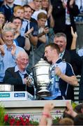 7 July 2013; Dublin captain John McCaffrey is presented with the Bob O'Keeffe Cup by Jimmy Gray who played in goal the last time Dublin won the cup. Leinster GAA Hurling Senior Championship Final, Galway v Dublin, Croke Park, Dublin. Picture credit: Ray McManus / SPORTSFILE