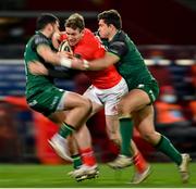 5 March 2021; Chris Farrell of Munster is tackled by Tiernan O'Halloran, left, and Dave Heffernan of Connacht during the Guinness PRO14 match between Munster and Connacht at Thomond Park in Limerick. Photo by Ramsey Cardy/Sportsfile
