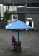 11 March 2021; Trainer Patricia Winters shelters from heavy rainfall prior to racing at Thurles Racecourse in Tipperary. Photo by David Fitzgerald/Sportsfile