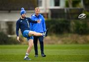15 March 2021; Harry Byrne, watched by head coach Leo Cullen, during Leinster Rugby Squad Training at UCD in Dublin.  Photo by Ramsey Cardy/Sportsfile