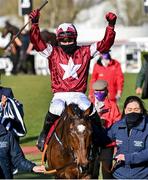17 March 2021; Jockey Keith Donoghue celebrates, as he is led into the winners enclosure, after winning The Glenfarclas Cross Country Steeple Chase on Tiger Roll on day 2 of the Cheltenham Racing Festival at Prestbury Park in Cheltenham, England. Photo by Hugh Routledge/Sportsfile