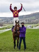19 March 2021; Jockey Jack Kennedy on Minella Indo, with handler Cathal Connolly, after winning The WellChild Cheltenham Gold Cup Steeple Chase during day 4 of the Cheltenham Racing Festival at Prestbury Park in Cheltenham, England. Photo by Hugh Routledge/Sportsfile