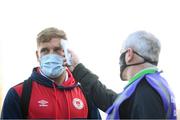 19 March 2021; Paddy Barrett of St Patrick's Athletic has his temperature taken by Shamrock Rovers COVID officer Eugene Coppinger on arrival before the SSE Airtricity League Premier Division match between Shamrock Rovers and St Patrick's Athletic at Tallaght Stadium in Dublin. Photo by Stephen McCarthy/Sportsfile