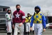 20 March 2021; Jockeys Jack Kennedy, left, and Rachael Blackmore makes their way to the parade ring through a guard of honour from fellow jockeys, following their successes at the Cheltenham Racing Festival, before the Leugh Handicap Hurdle at Thurles Racecourse in Tipperary. Photo by Seb Daly/Sportsfile