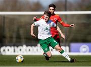 26 March 2021; Luca Connell of Republic of Ireland in action against Niall Huggins of Wales during the U21 international friendly match between Wales and Republic of Ireland at Colliers Park in Wrexham, Wales. Photo by David Rawcliffe/Sportsfile