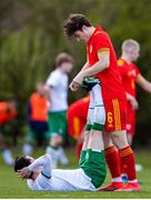 26 March 2021; Morgan Boyes of Wales assists Louie Watson of Republic of Ireland with a cramp during the U21 International friendly match between Wales and Republic of Ireland at Colliers Park in Wrexham, Wales. Photo by David Rawcliffe/Sportsfile