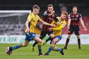 27 March 2021; Liam Burt of Bohemians is tackled by Aodh Dervin, right, and Paddy Kirk of Longford Town during the SSE Airtricity League Premier Division match between Bohemians and Longford Town at Dalymount Park in Dublin. Photo by Sam Barnes/Sportsfile