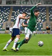 28 March 2021; Kyle Lafferty of Northern Ireland is tackled by Aaron Long of USA during the International friendly match between Northern Ireland and USA at the National Football Stadium at Windsor Park in Belfast. Photo by David Fitzgerald/Sportsfile