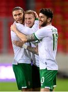 30 March 2021; Republic of Ireland's James McClean celebrates with team-mates Robbie Brady, right, and Jeff Hendrick, left, after scoring his side's goal during the international friendly match between Qatar and Republic of Ireland at Nagyerdei Stadion in Debrecen, Hungary. Photo by Stephen McCarthy/Sportsfile