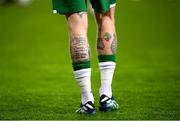 30 March 2021; A detailed view of tattoo's on the legs of James McClean of Republic of Ireland featuring an autism awareness symbol and the text of &quot;The Serenity Prayer&quot; before the international friendly match between Qatar and Republic of Ireland at Nagyerdei Stadion in Debrecen, Hungary. Photo by Stephen McCarthy/Sportsfile