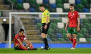 31 March 2021; Georgi Kostadinov of Bulgaria, left, waits for medical attention watched by referee Yigal Frid during the FIFA World Cup 2022 qualifying group C match between Northern Ireland and Bulgaria at the National Football Stadium in Windsor Park, Belfast. Photo by David Fitzgerald/Sportsfile