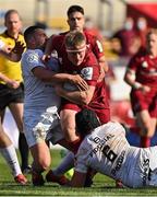 3 April 2021; John Ryan of Munster is tackled by Dorian Aldegheri, left, and Francois Cros, both  of Toulouse, during the Heineken Champions Cup Round of 16 match between Munster and Toulouse at Thomond Park in Limerick. Photo by Brendan Moran/Sportsfile