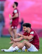 3 April 2021; Romain Ntamack of Toulouse on his phone whilst wearing a Munster jersey after the Heineken Champions Cup Round of 16 match between Munster and Toulouse at Thomond Park in Limerick. Photo by Ramsey Cardy/Sportsfile