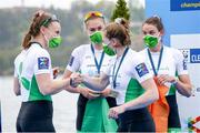 11 April 2021; Aifric Keogh of Ireland, left, shakes hand with Emily Hegarty as Eimear Lambe and Fiona Murtagh look on after being awarded silver medals from the Women's Four A Final during Day 3 of the European Rowing Championships 2021 at Varese in Italy. Photo by Roberto Bregani/Sportsfile