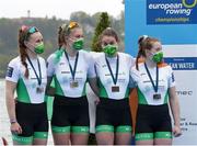 11 April 2021; Ireland rowers, from left, Aifric Keogh, Eimear Lambe, Fiona Murtagh and Emily Hegarty celebrate with their silver medals after the Women's Four A Final during Day 3 of the European Rowing Championships 2021 at Varese in Italy. Photo by Roberto Bregani/Sportsfile