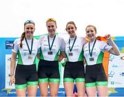 11 April 2021; Ireland rowers, from left, Aifric Keogh, Eimear Lambe, Fiona Murtagh and Emily Hegarty celebrate with their silver medals after the Women's Four A Final during Day 3 of the European Rowing Championships 2021 at Varese in Italy. Photo by Roberto Bregani/Sportsfile
