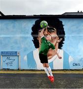 12 April 2021; Local resident Johnny Figo Murphy, age 9, from Dublin imitates the famous 'Hand of God' in front of a mural by Dublin artist Chelsea Jacobs depicting the late Argentine footballer Diego Maradona at Havelock Square in Dublin. Photo by David Fitzgerald/Sportsfile