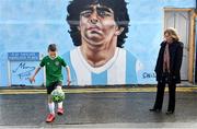 12 April 2021; Her Excellency Mrs. S. Moira Wilkinson, Argentine Ambassador to the Republic of Ireland, watches local resident Johnny Figo Murphy, aged 9, from Sandymount Dublin showing off his skills in front of a mural by Dublin artist Chelsea Jacobs depicting the late Argentine footballer Diego Maradona at Havelock Square in Dublin. Photo by David Fitzgerald/Sportsfile