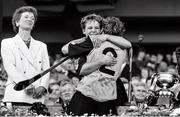 22 September 1991; Kilkenny captain Angela Downey celebrates with team-mate Biddy O'Sullivan, 2, in the company of President Mary Robinson after the All Ireland Camogie Final match between Kilkenny and Cork at Croke Park in Dublin. Photo by Ray McManus/Sportsfile