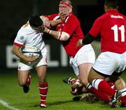 6 February 2004; Ulster's Kieran Campbell is tackled by Llaneli's Phil John. Celtic League, Ulster v Llanelli, Ravenhill Park, Belfast. Picture credit; SPORTSFILE