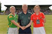 13 July 2013; Kerry captain Bernie Breen and Cork captain Ann Marie Walsh exchange a handshake in the company of referee Mike Duffy before the game. TG4 Ladies Football Munster Senior Championship Final, Kerry v Cork, Castletownroche, Cork. Picture credit: Diarmuid Greene / SPORTSFILE