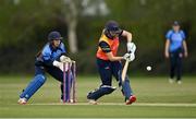 2 May 2021; Gaby Lewis of Scorchers plays a shot, watched by Typhoons wicketkeeper Amy Hunter, during the Arachas Super 50 Cup 2021 match between Typhoons and Scorchers at Pembroke Cricket Club in Dublin. Photo by Seb Daly/Sportsfile