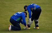 1 May 2021; Shane Getkate of North West Warriors ties the shoelaces of team-mate and wicketkeeper Stephen Doheny during the Inter-Provincial Cup 2021 match between Leinster Lightning and North West Warriors at Pembroke Cricket Club in Dublin. Photo by Brendan Moran/Sportsfile