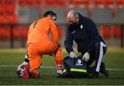 3 May 2021; Finn Harps physiotherapist Conall McFadden gives medical attention to Finn Harps goalkeeper Mark Anthony McGinley during the SSE Airtricity League Premier Division match between Derry City and Finn Harps at the Ryan McBride Brandywell Stadium in Derry. Photo by Stephen McCarthy/Sportsfile