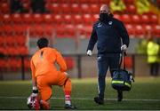 3 May 2021; Finn Harps physiotherapist Conall McFadden comes onto the pitch to give medical attention to Finn Harps goalkeeper Mark Anthony McGinley during the SSE Airtricity League Premier Division match between Derry City and Finn Harps at the Ryan McBride Brandywell Stadium in Derry. Photo by Stephen McCarthy/Sportsfile