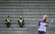 9 May 2021; Two stewards sit socially distanced in the empty stand as Wexford goalkeeper Seamus Casey pucks the sliotar out during the Allianz Hurling League Division 1 Group B Round 1 match between Wexford and Laois at Chadwicks Wexford Park in Wexford. Photo by Brendan Moran/Sportsfile