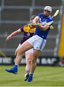 9 May 2021; Ryan Mullanney of Laois is hooked by David Dunne of Wexford during the Allianz Hurling League Division 1 Group B Round 1 match between Wexford and Laois at Chadwicks Wexford Park in Wexford. Photo by Brendan Moran/Sportsfile