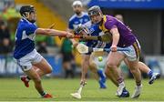 9 May 2021; Mikie Dwyer of Wexford is tackled by Donnchadh Hartnett, left, and Lee Cleere of Laois during the Allianz Hurling League Division 1 Group B Round 1 match between Wexford and Laois at Chadwicks Wexford Park in Wexford. Photo by Brendan Moran/Sportsfile