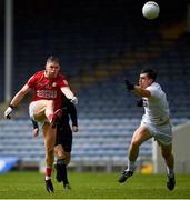 15 May 2021; Cathail O'Mahony of Cork kicks the ball goal wards under pressure from Mark Dempsey of Kildare during the Allianz Football League Division 2 South Round 1 match between Cork and Kildare at Semple Stadium in Thurles, Tipperary. Photo by Ray McManus/Sportsfile