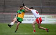 15 May 2021; Hugh McFadden of Donegal in action against Brian Kennedy of Tyrone during the Allianz Football League Division 1 North Round 1 match between Tyrone and Donegal at Healy Park in Omagh, Tyrone. Photo by Stephen McCarthy/Sportsfile